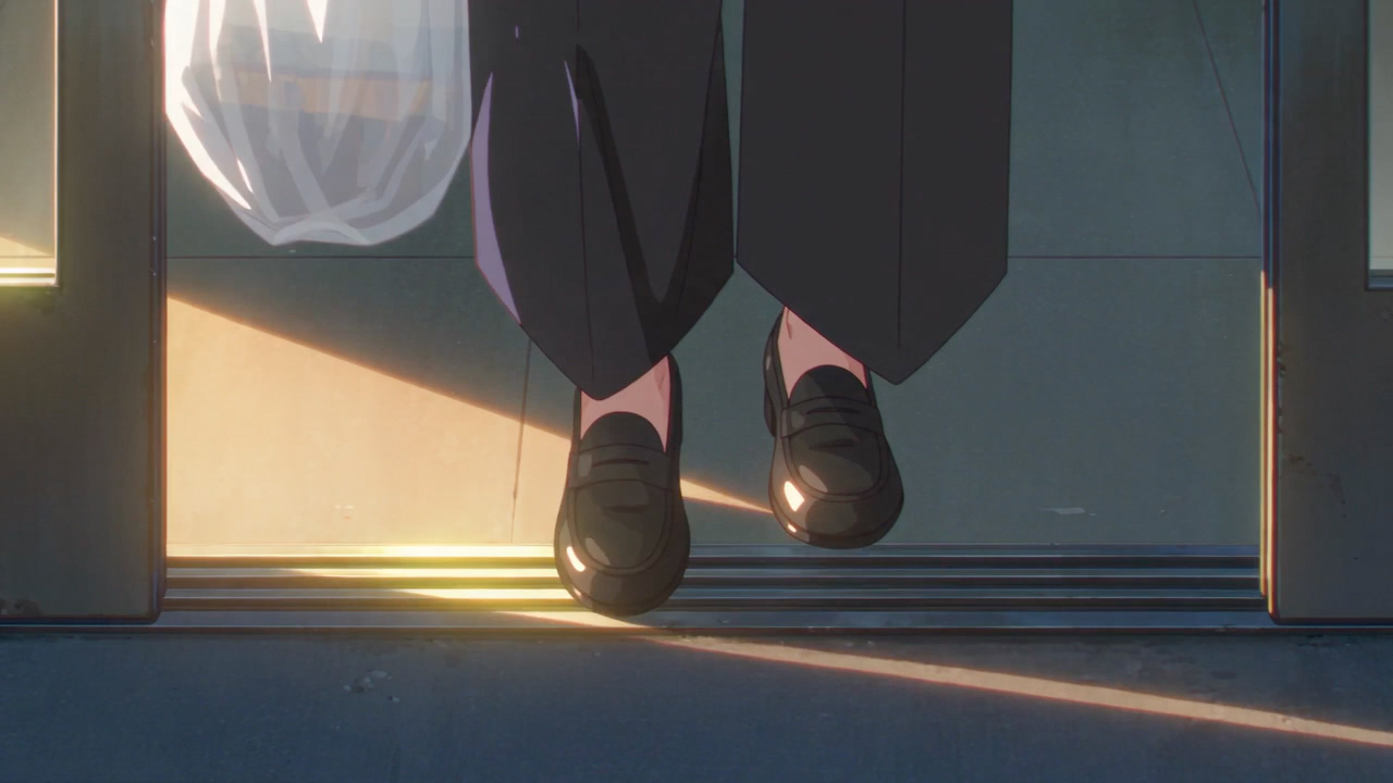 Her loafers step out through the sliding doors